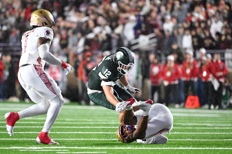 Sep 21, 2024; Chestnut Hill, Massachusetts, USA; Boston College Eagles defensive back Carter Davis (28) intercepts a pass meant for Michigan State Spartans tight end Jack Velling (12) during the first half at Alumni Stadium. Mandatory Credit: Eric Canha-Imagn Images