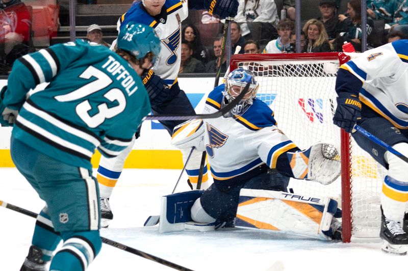 Oct 10, 2024; San Jose, California, USA; San Jose Sharks center Tyler Toffoli (73) shoots the puck past St. Louis Blues goaltender Joel Hofer (30) during the first period at SAP Center at San Jose. Mandatory Credit: Stan Szeto-Imagn Images