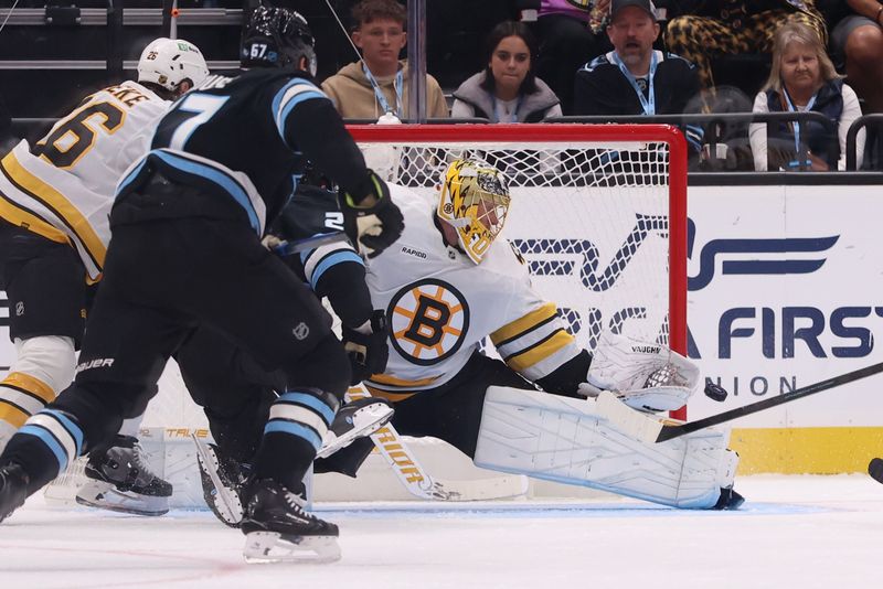 Oct 19, 2025; Salt Lake City, Utah, USA; Boston Bruins goaltender Joonas Korpisalo (70) deflects a shot by the Utah Mammoth during the second period at Delta Center. Mandatory Credit: Rob Gray-Imagn Images