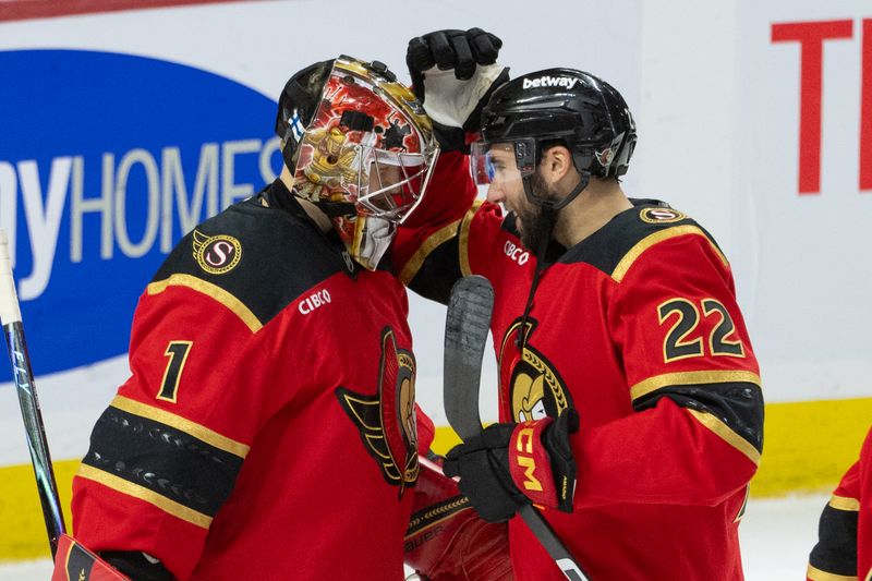 Oct 27, 2025; Ottawa, Ontario, CAN; Ottawa Senators right wing Michael Amadio (22) congratulates goaltender Leevi Merilainen (1) following the win against the Boston Bruins at the Canadian Tire Centre. Mandatory Credit: Marc DesRosiers-IMAGN Images