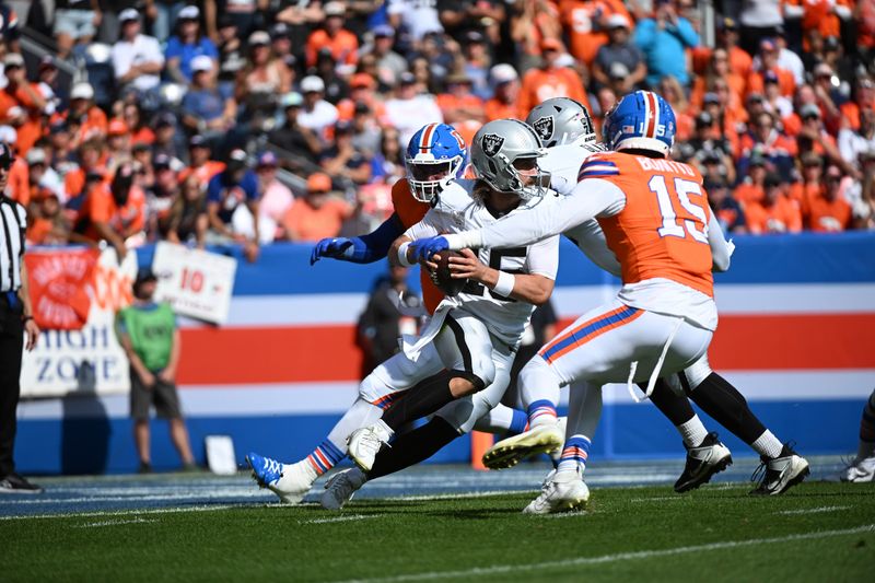 Las Vegas Raiders quarterback Gardner Minshew rushes during the first half of an NFL football game against the Denver Broncos, Sunday, Oct. 6, 2024, in Denver. (AP Photo/Geneva Heffernan)