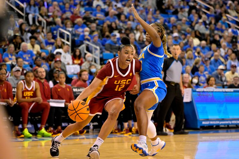 Dec 30, 2023; Los Angeles, California, USA;  USC Trojans guard JuJu Watkins (12) is defended by UCLA Bruins guard Charisma Osborne (20) in the second half at Pauley Pavilion presented by Wescom. Mandatory Credit: Jayne Kamin-Oncea-USA TODAY Sports