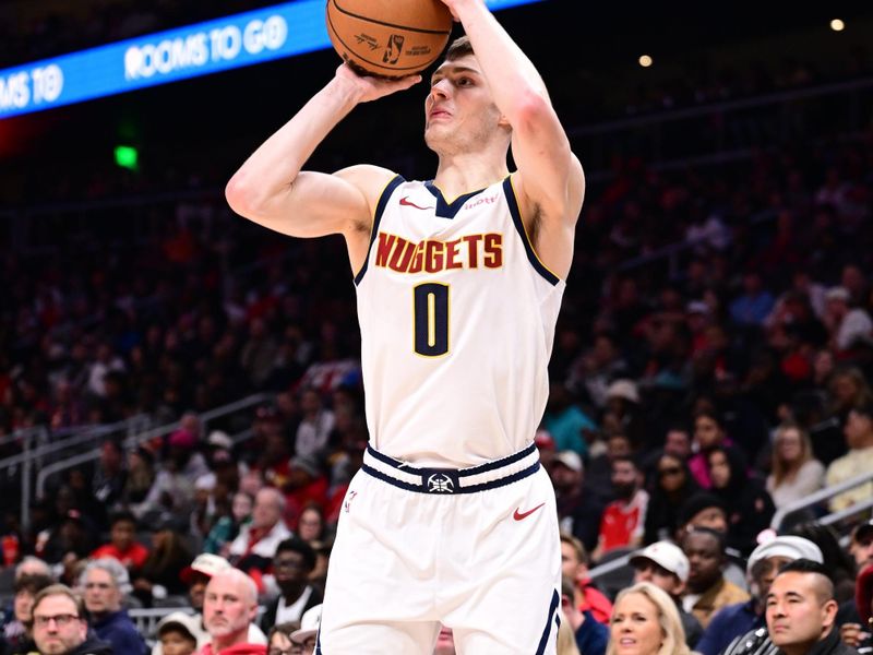 ATLANTA, GA - DECEMBER 8: Christian Braun #0 of the Denver Nuggets shoots the ball during the game against the Atlanta Hawks on December 8, 2024 at State Farm Arena in Atlanta, Georgia.  NOTE TO USER: User expressly acknowledges and agrees that, by downloading and/or using this Photograph, user is consenting to the terms and conditions of the Getty Images License Agreement. Mandatory Copyright Notice: Copyright 2024 NBAE (Photo by Adam Hagy/NBAE via Getty Images)