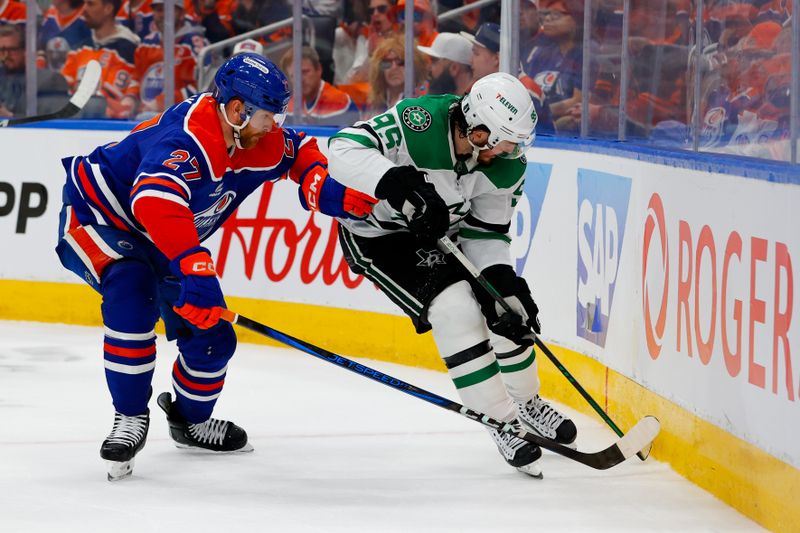 May 25, 2025; Edmonton, Alberta, CAN; Edmonton Oilers defenseman Brett Kulak (27) and Dallas Stars center Matt Duchene (95) battle for the puck during the second period in game three of the Western Conference Final of the 2025 Stanley Cup Playoffs at Rogers Place. Mandatory Credit: Perry Nelson-Imagn Images