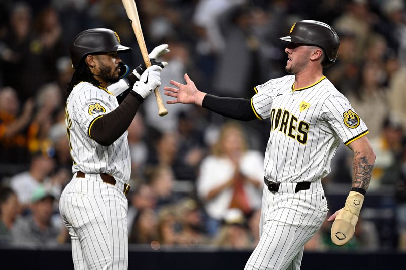 Jun 10, 2024; San Diego, California, USA; San Diego Padres center fielder Jackson Merrill (right) is congratulated by catcher Luis Campusano (12) after scoring a run against the Oakland Athletics during the fourth inning at Petco Park. Mandatory Credit: Orlando Ramirez-USA TODAY Sports