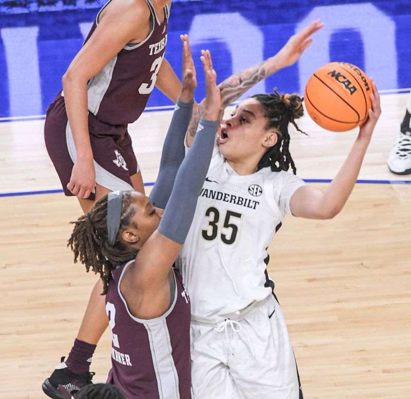 Mar 1, 2023; Greenville, SC, USA; Vanderbilt forward Sacha Washington (35) shoots near Texas A&M forward Janiah Barker (2) during the first quarter of the SEC Women's Basketball Tournament at Bon Secours Wellness Arena. Mandatory Credit: Ken Ruinard-USA TODAY Sports