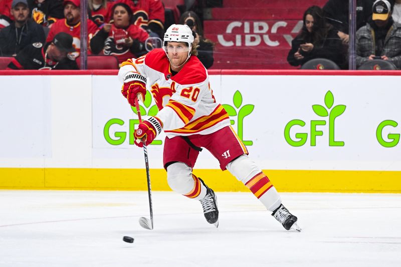 Nov 25, 2024; Ottawa, Ontario, CAN; Calgary Flames center Blake Coleman (20) plays the puck against the Ottawa Senators during the first period at Canadian Tire Centre. Mandatory Credit: David Kirouac-Imagn Images