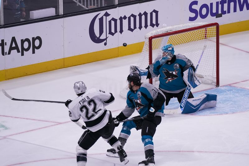 Nov 20, 2025; San Jose, California, USA;  Los Angeles Kings left winger Kevin Fiala (22) shoots the puck while defended by San Jose Sharks defenseman Timothy Liljegren (37) and goaltender Yaroslav Askarov (30) in the third period at SAP Center at San Jose. Mandatory Credit: David Gonzales-Imagn Images
