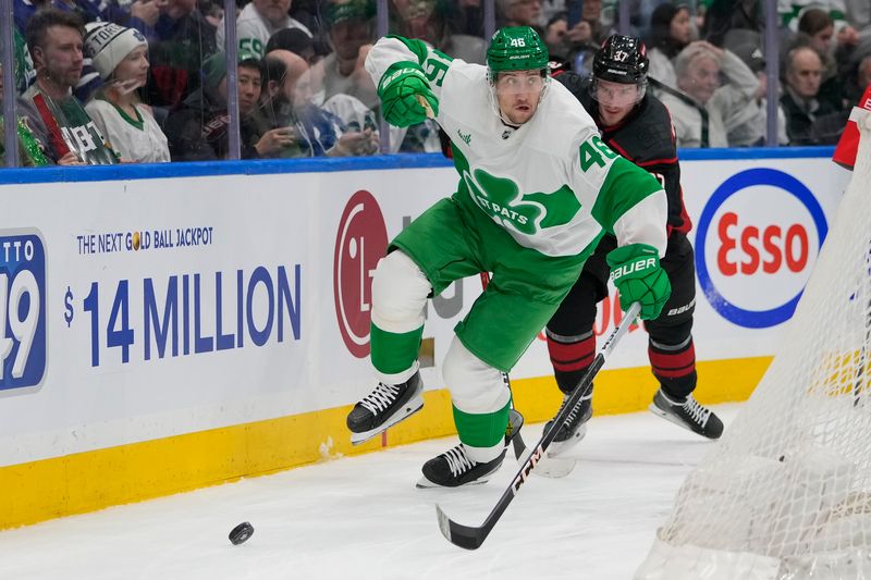 Mar 16, 2024; Toronto, Ontario, CAN; Toronto Maple Leafs defenseman Ilya Lyubushkin (46) chases after a loose puck against the Carolina Hurricanes during the second period at Scotiabank Arena. Mandatory Credit: John E. Sokolowski-USA TODAY Sports