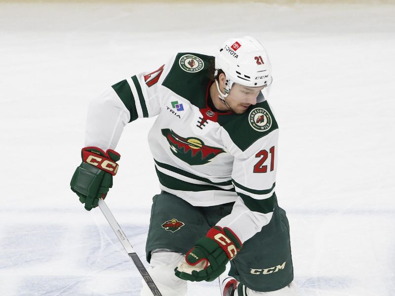 Feb 7, 2024; Chicago, Illinois, USA; Minnesota Wild right wing Brandon Duhaime (21) controls the puck against the Chicago Blackhawks during the second period at United Center. Mandatory Credit: Kamil Krzaczynski-USA TODAY Sports