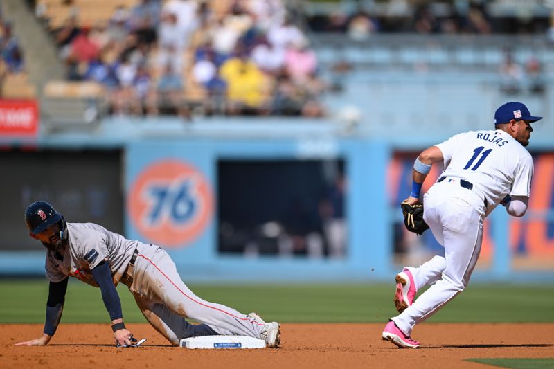 Jul 21, 2024; Los Angeles, California, USA; Boston Red Sox catcher Connor Wong (12) steal second base against Los Angeles Dodgers shortstop Miguel Rojas (11) during the first inning at Dodger Stadium. Mandatory Credit: Jonathan Hui-USA TODAY Sports