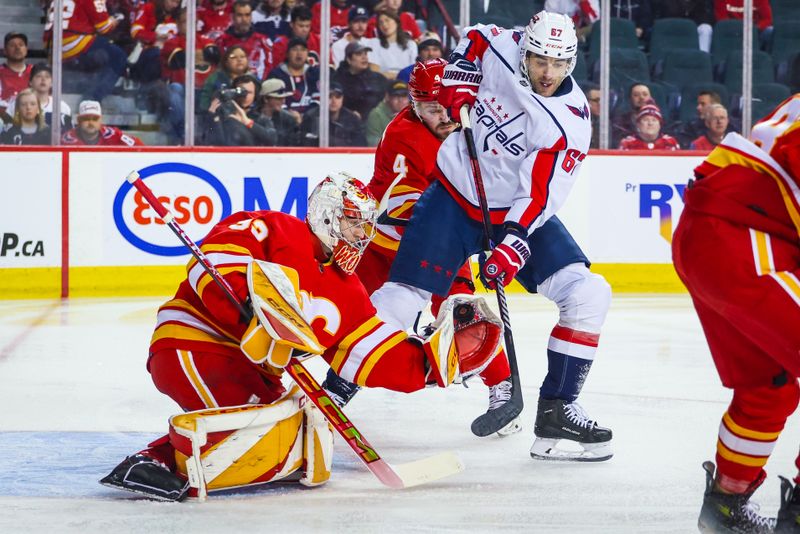 Mar 18, 2024; Calgary, Alberta, CAN; Calgary Flames goaltender Dustin Wolf (32) makes a save against the Washington Capitals during the first period at Scotiabank Saddledome. Mandatory Credit: Sergei Belski-USA TODAY Sports