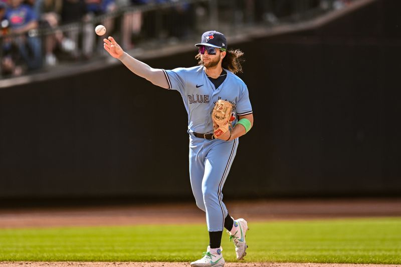 Jun 4, 2023; New York City, New York, USA; Toronto Blue Jays shortstop Bo Bichette (11) throws to first base for an out during the seventh inning against the New York Mets at Citi Field. Mandatory Credit: John Jones-USA TODAY Sports