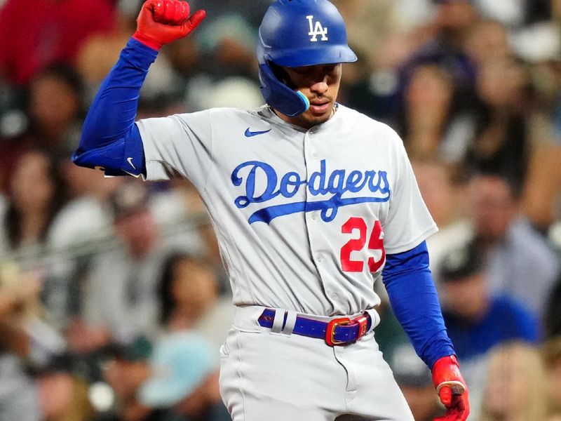 Sep 28, 2023; Denver, Colorado, USA; Los Angeles Dodgers second baseman Kolten Wong (25) reacts to his single in the seventh inning against the Colorado Rockies at Coors Field. Mandatory Credit: Ron Chenoy-USA TODAY Sports