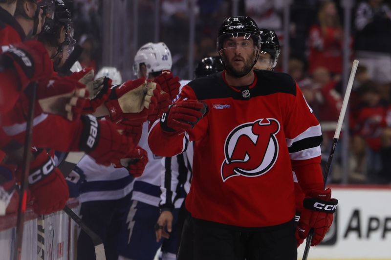 Oct 22, 2024; Newark, New Jersey, USA; New Jersey Devils right wing Stefan Noesen (11) celebrates his goal against the Tampa Bay Lightning during the third period at Prudential Center. Mandatory Credit: Ed Mulholland-Imagn Images