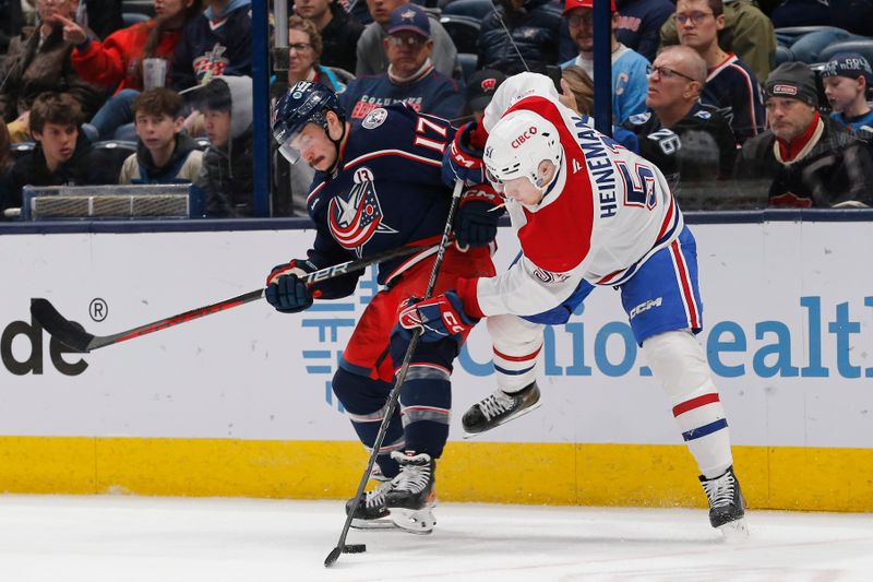 Nov 27, 2024; Columbus, Ohio, USA; Montreal Canadiens left wing Emil Heineman (51) and Columbus Blue Jackets right wing Justin Danforth (17) battle for the puck during the second period at Nationwide Arena. Mandatory Credit: Russell LaBounty-Imagn Images