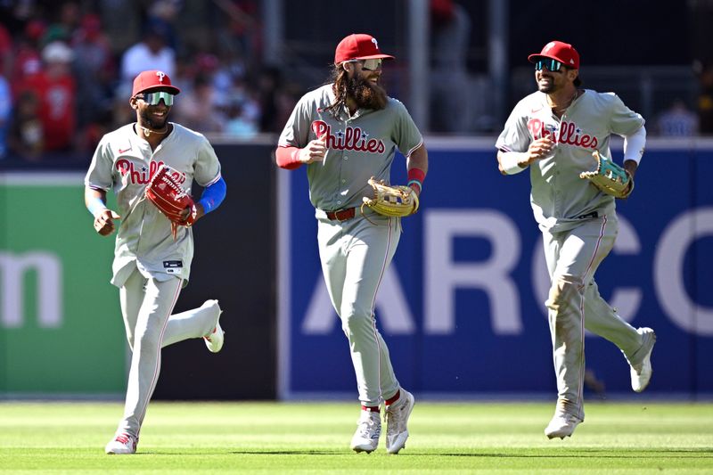 Apr 28, 2024; San Diego, California, USA; Philadelphia Phillies center fielder Johan Rojas (left) runs off the field alongside left fielder Brandon Marsh (center) and right fielder Nick Castellanos (right) after defeating the San Diego Padres at Petco Park. Mandatory Credit: Orlando Ramirez-USA TODAY Sports