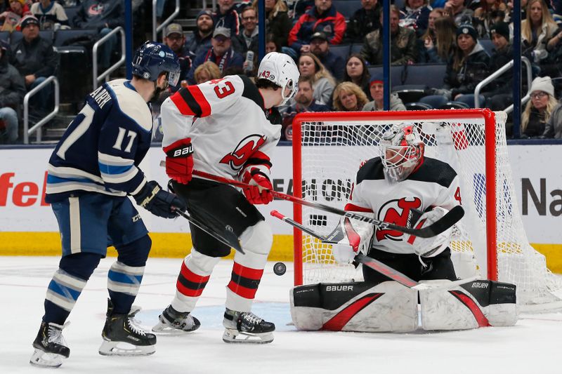 Jan 19, 2024; Columbus, Ohio, USA; New Jersey Devils goalie Vitek Vanecek (41) makes a blocker save as Columbus Blue Jackets right wing Justin Danforth (17) looks for a rebound during the third period at Nationwide Arena. Mandatory Credit: Russell LaBounty-USA TODAY Sports