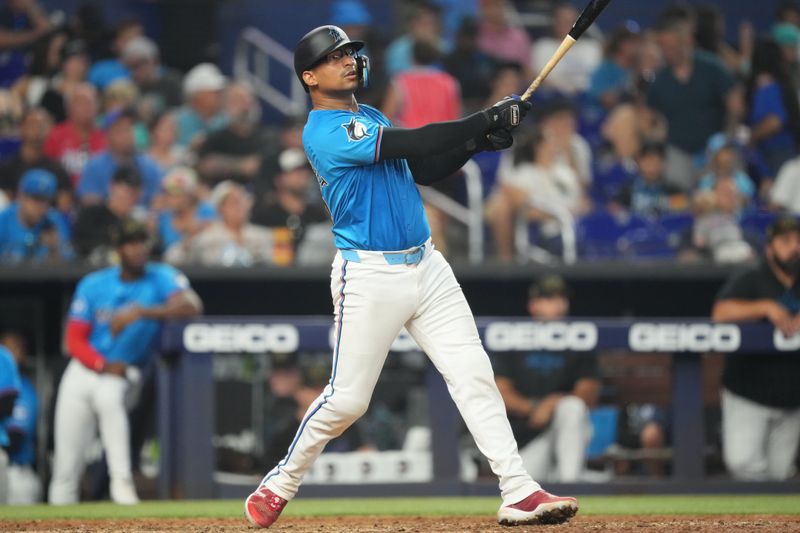 May 19, 2024; Miami, Florida, USA;  Miami Marlins catcher Christian Bethancourt (25) watches his home run leave the park in the seventh inning against the New York Mets at loanDepot Park. Mandatory Credit: Jim Rassol-USA TODAY Sports