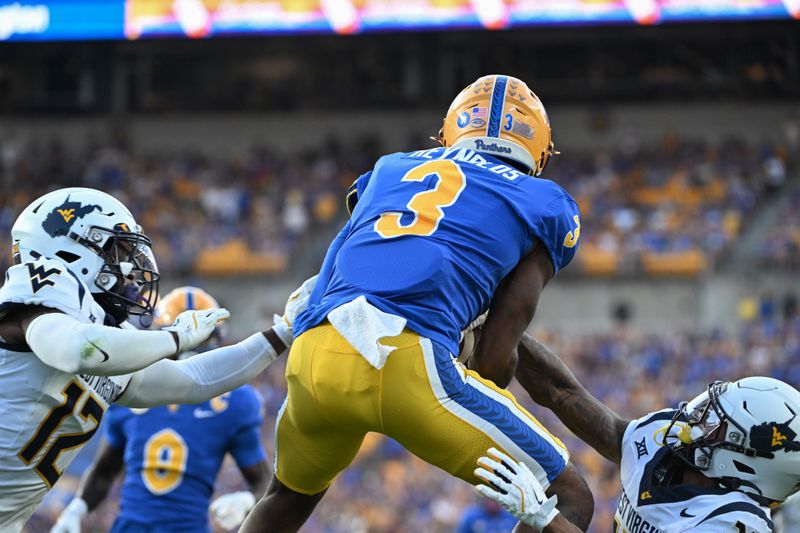 Sep 14, 2024; Pittsburgh, Pennsylvania, USA; Pittsburgh Panthers wide receiver Daejon Reynolds (3) catches a touchdown pass in front of West Virginia Mountaineers defenders Anthony Wilson Jr. (12) and Dontez Fagan in the fourth quarter at Acrisure Stadium. Mandatory Credit: Barry Reeger-Image Images