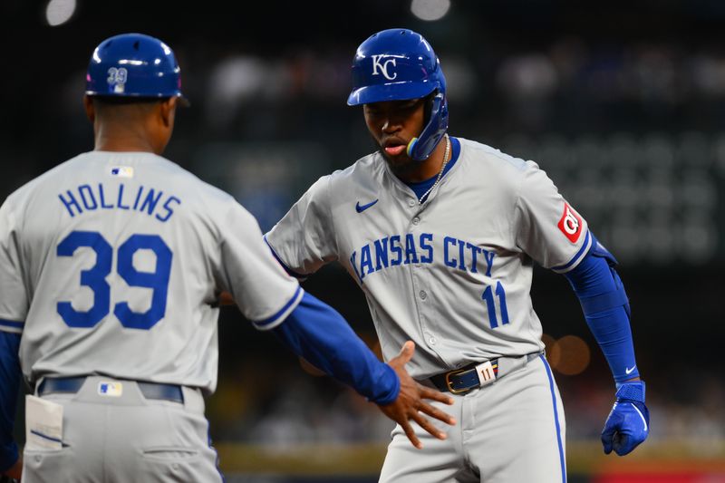 May 14, 2024; Seattle, Washington, USA; Kansas City Royals first base coach Damon Hollins (39) and third baseman Maikel Garcia (11) celebrate after Garcia hit an RBI single against the Seattle Mariners during the eighth inning at T-Mobile Park. Mandatory Credit: Steven Bisig-USA TODAY Sports