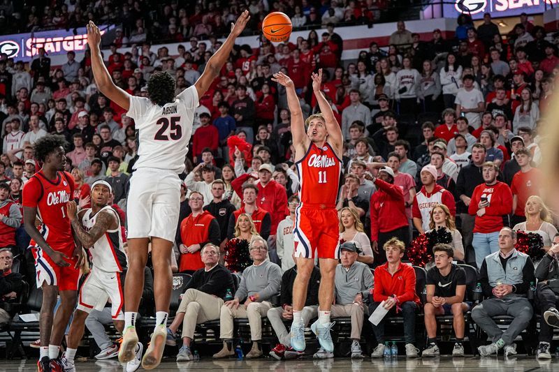 Jan 14, 2026; Athens, Georgia, USA; Mississippi Rebels guard Travis Perry (11) shoots over Georgia Bulldogs forward Justin Abson (25) during the second half at Stegeman Coliseum. Mandatory Credit: Dale Zanine-Imagn Images