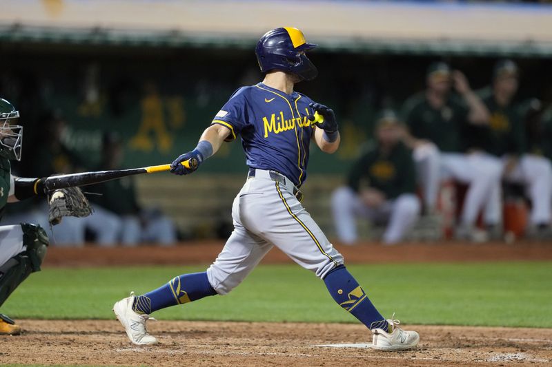 Aug 23, 2024; Oakland, California, USA; Milwaukee Brewers right fielder Sal Frelick (10) hits a single against the Oakland Athletics during the eighth inning at Oakland-Alameda County Coliseum. Mandatory Credit: Darren Yamashita-USA TODAY Sports