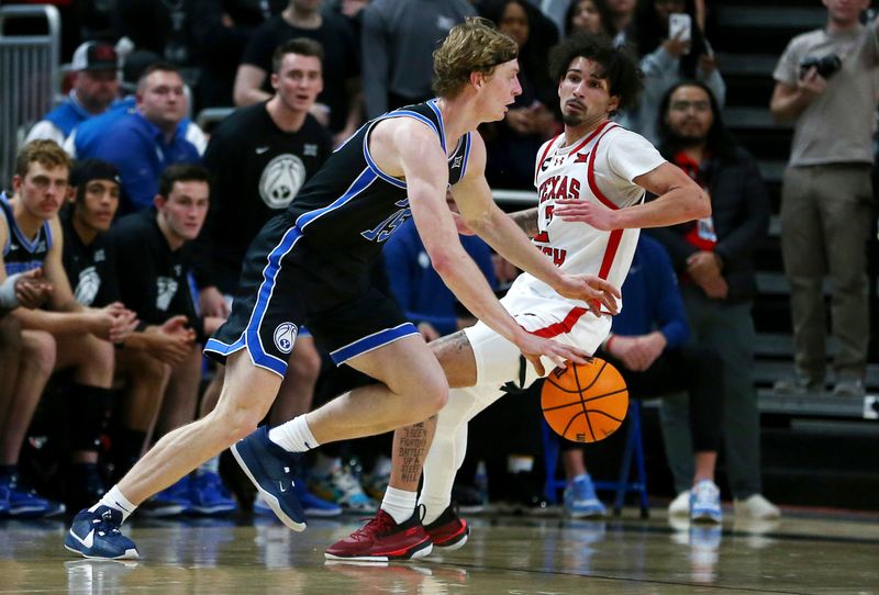 Jan 20, 2024; Lubbock, Texas, USA;  Brigham Young Cougars guard Richie Saunders (15) dribbles the ball against Texas Tech Red Raiders guard Pop Isaacs (2) in the second half at United Supermarkets Arena. Mandatory Credit: Michael C. Johnson-USA TODAY Sports