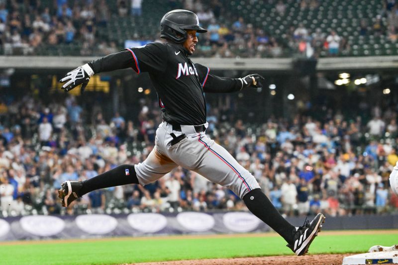 Jul 28, 2024; Milwaukee, Wisconsin, USA; Miami Marlins shortstop Xavier Edwards (63) beats out an infield hit in the ninth inning to complete hitting for the cycle against the Milwaukee Brewers at American Family Field. Mandatory Credit: Benny Sieu-USA TODAY Sports