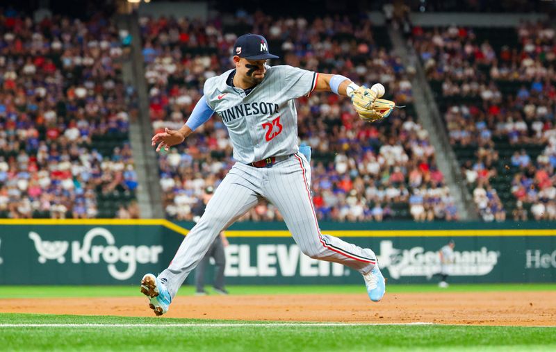 Aug 17, 2024; Arlington, Texas, USA;  Minnesota Twins third baseman Royce Lewis (23) cannot cleanly field a ground ball at third base during the second inning against the Texas Rangers at Globe Life Field. Mandatory Credit: Kevin Jairaj-USA TODAY Sports