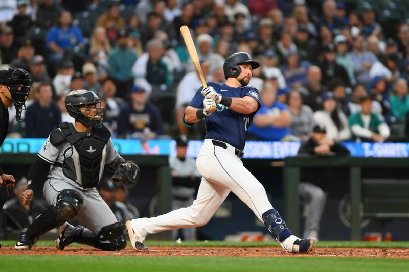 Jun 11, 2024; Seattle, Washington, USA; Seattle Mariners catcher Cal Raleigh (29) hits a 2-RBI double against the Chicago White Sox during the seventh inning at T-Mobile Park. Mandatory Credit: Steven Bisig-USA TODAY Sports