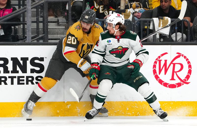 Apr 12, 2024; Las Vegas, Nevada, USA; Vegas Golden Knights center Chandler Stephenson (20) protects the puck from Minnesota Wild center Marat Khusnutdinov (22) during the second period at T-Mobile Arena. Mandatory Credit: Stephen R. Sylvanie-USA TODAY Sports