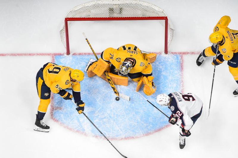 Apr 13, 2024; Nashville, Tennessee, USA; Nashville Predators goaltender Juuse Saros (74) blocks the shot Columbus Blue Jackets left wing Alexander Nylander (92) during the first period at Bridgestone Arena. Mandatory Credit: Steve Roberts-USA TODAY Sports