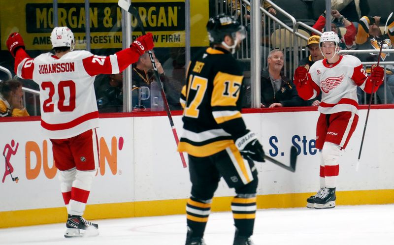 Oct 1, 2024; Pittsburgh, Pennsylvania, USA;  Detroit Red Wings center Nate Danielson (right) celebrates with defenseman Albert Johansson (20) after scoring a goal against the Pittsburgh Penguins during the third period at PPG Paints Arena. Detroit won 2-1. Mandatory Credit: Charles LeClaire-Imagn Images