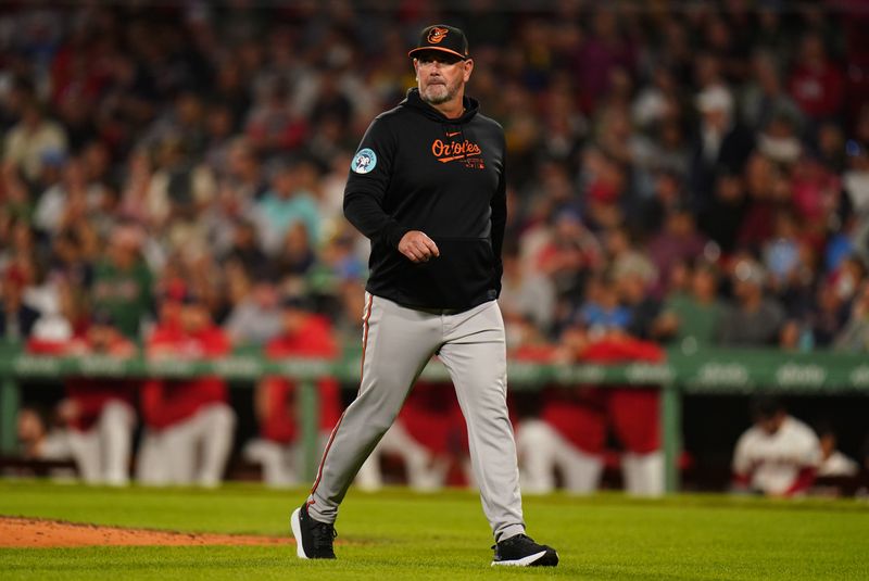 Sep 9, 2024; Boston, Massachusetts, USA; Baltimore Orioles manager Brandon Hyde (18) heads back to the dugout after replacing pitchers against the Boston Red Sox in the sixth inning at Fenway Park. Mandatory Credit: David Butler II-Imagn Images