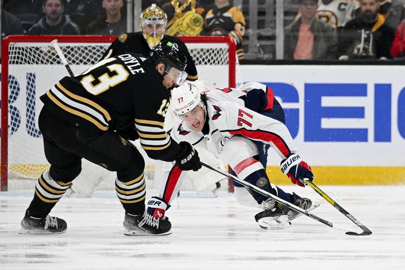 Feb 10, 2024; Boston, Massachusetts, USA; Washington Capitals right wing T.J. Oshie (77) and Boston Bruins center Charlie Coyle (13) reach for a puck during the first period at the TD Garden. Mandatory Credit: Brian Fluharty-USA TODAY Sports