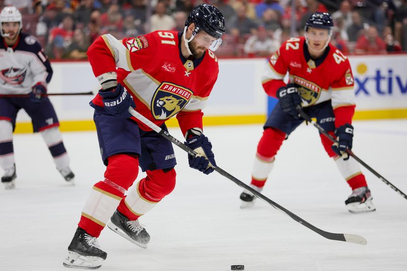 Nov 6, 2023; Sunrise, Florida, USA; Florida Panthers defenseman Oliver Ekman-Larsson (91) moves the puck against the Columbus Blue Jackets during the second period at Amerant Bank Arena. Mandatory Credit: Sam Navarro-USA TODAY Sports