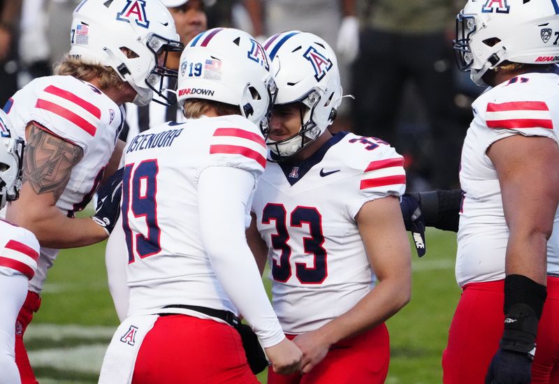 Nov 11, 2023; Boulder, Colorado, USA; Arizona Wildcats place kicker Tyler Loop (33) and punter Kyle Ostendorp (19) celebrate after defeating the Colorado Buffaloes at Folsom Field. Mandatory Credit: Ron Chenoy-USA TODAY Sports