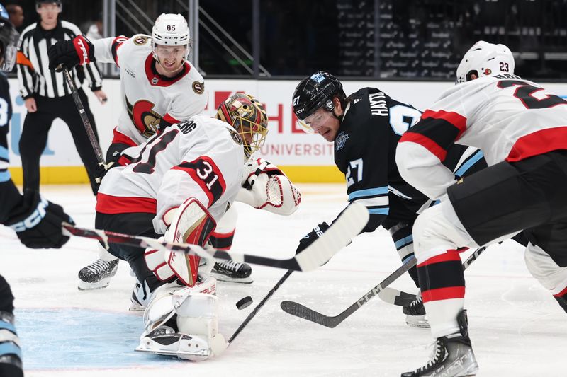 Oct 22, 2024; Salt Lake City, Utah, USA; Ottawa Senators goaltender Anton Forsberg (31) deflects the puck from Utah Hockey Club center Barrett Hayton (27) during the second period at Delta Center. Mandatory Credit: Rob Gray-Imagn Images