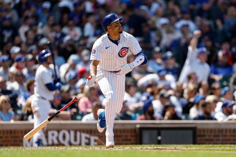 May 3, 2024; Chicago, Illinois, USA; Chicago Cubs third baseman Christopher Morel (5) watches his solo home run against the Milwaukee Brewers during the sixth inning at Wrigley Field. Mandatory Credit: Kamil Krzaczynski-USA TODAY Sports