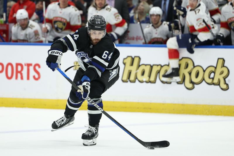 Feb 17, 2024; Tampa, Florida, USA;  Tampa Bay Lightning center Tyler Motte (64) passes the puck against the Florida Panthers in the first period at Amalie Arena. Mandatory Credit: Nathan Ray Seebeck-USA TODAY Sports