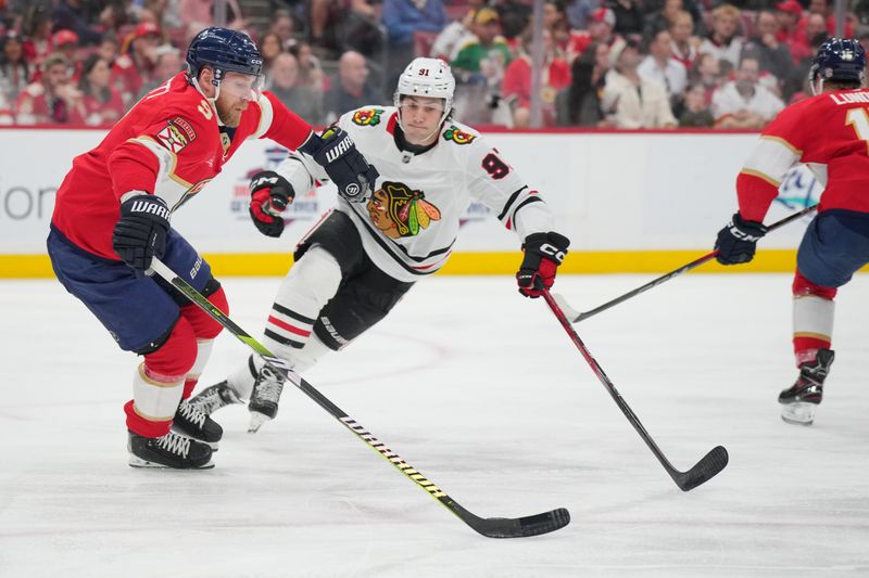 Feb 1, 2025; Sunrise, Florida, USA;  Chicago Blackhawks center Frank Nazar (91) closes in on Florida Panthers center Sam Bennett (9) in the first period at Amerant Bank Arena. Mandatory Credit: Jim Rassol-Imagn Images