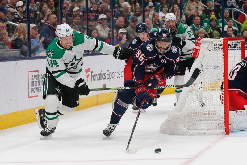 Feb 25, 2025; Columbus, Ohio, USA; Columbus Blue Jackets right wing Kirill Marchenko (86) and Dallas Stars center Mikael Granlund (64) chase down a loose puck during the first period at Nationwide Arena. Mandatory Credit: Russell LaBounty-Imagn Images