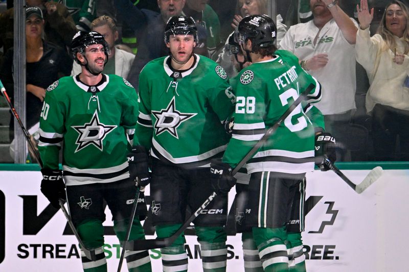 Nov 4, 2025; Dallas, Texas, USA; Dallas Stars defenseman Kyle Capobianco (20) and right wing Mikko Rantanen (96) and defenseman Alexander Petrovic (28) celebrates a goal scored by Rantanen against the Edmonton Oilers during the third period at the American Airlines Center. Mandatory Credit: Jerome Miron-Imagn Images