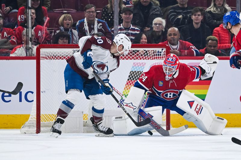 Jan 15, 2024; Montreal, Quebec, CAN; Montreal Canadiens goalie Sam Montembeault (35) makes a save against Colorado Avalanche center Ross Colton (20) during the first period at Bell Centre. Mandatory Credit: David Kirouac-USA TODAY Sports