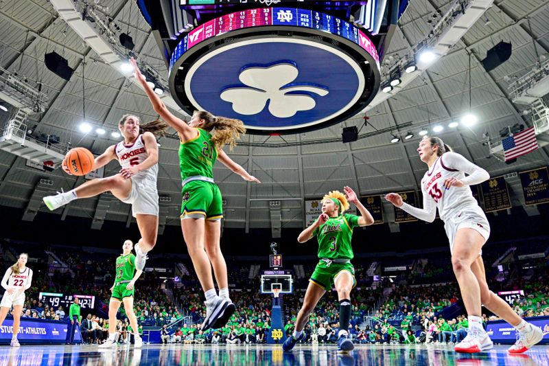 Feb 29, 2024; South Bend, Indiana, USA; Virginia Tech Hokies guard Georgia Amoore (5) passes the ball as Notre Dame Fighting Irish forward Maddy Westbeld (21) defends in the second half at the Purcell Pavilion. Mandatory Credit: Matt Cashore-USA TODAY Sports