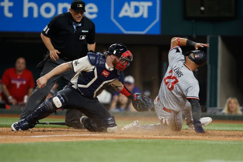 Sep 2, 2023; Arlington, Texas, USA; Minnesota Twins third baseman Royce Lewis (23) scores a run and avoids the tag of Texas Rangers catcher Jonah Heim (28) in the tenth inning at Globe Life Field. Mandatory Credit: Tim Heitman-USA TODAY Sports