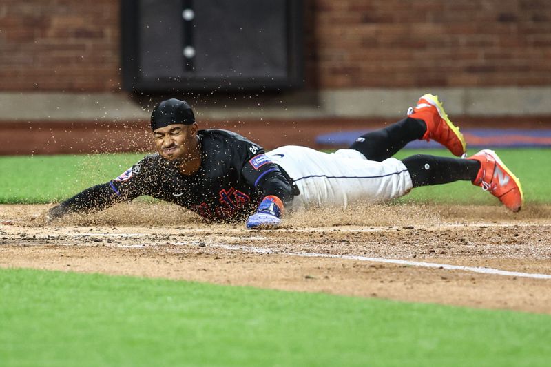 Sep 2, 2024; New York City, New York, USA;  New York Mets shortstop Francisco Lindor (12) slides safely into home plate against the Boston Red Sox in the third inning at Citi Field. Mandatory Credit: Wendell Cruz-USA TODAY Sports