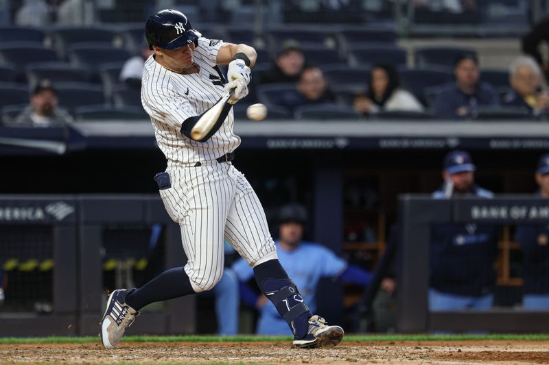 Apr 27, 2025; Bronx, New York, USA; New York Yankees shortstop Anthony Volpe (11) singles during the eighth inning against the Toronto Blue Jays at Yankee Stadium. Mandatory Credit: Vincent Carchietta-Imagn Images