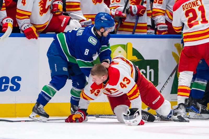 Apr 16, 2024; Vancouver, British Columbia, CAN; Calgary Flames forward Adam Klapka (43) wrestles with Vancouver Canucks forward Conor Garland (8) in the second period at Rogers Arena. Mandatory Credit: Bob Frid-USA TODAY Sports